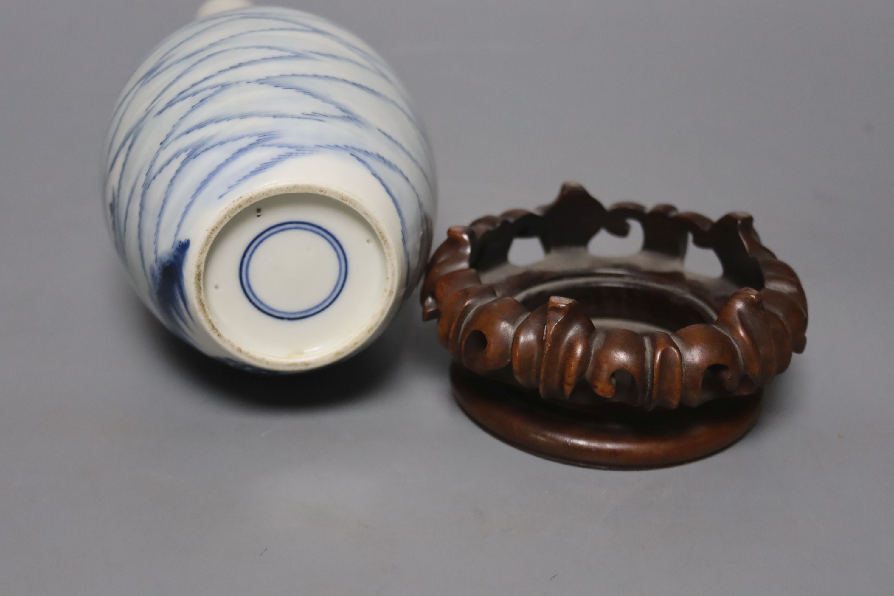 A Chinese blue and white bottle vase, with hardwood stand 23.5cm.